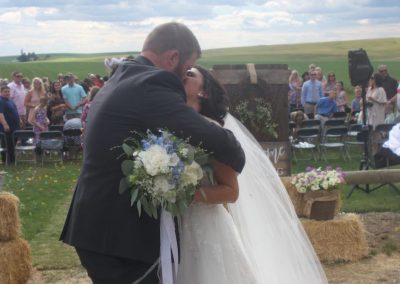 Bride and groom kissing after outdoor wedding